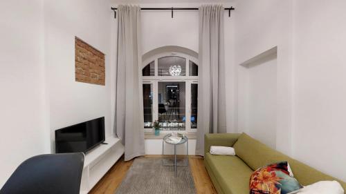 a living room with a couch and a tv at APARTHOTEL TECTUM in Wrocław