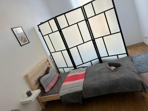 a bedroom with a large bed and a chair at Studio-Apartment in zentraler Lage in Graz