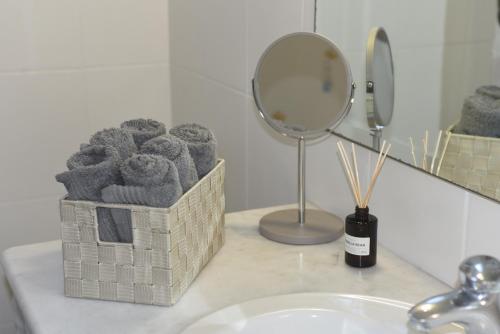 a bathroom counter with a sink and a mirror at VILLAGE HOUSE in Tríkala