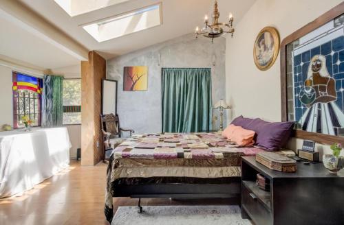 a bedroom with a bed and a tub in it at Hillmont paradise in Oakland