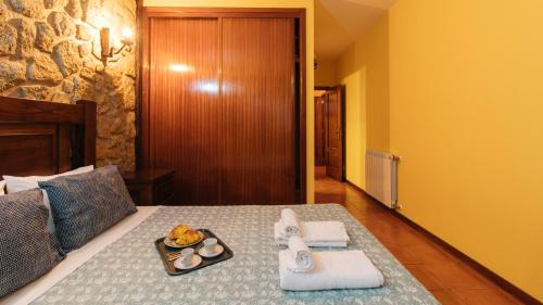 een hotelkamer met een bed en een dienblad met eten erop bij Casa Quinta das Vessadas in Celorico de Basto