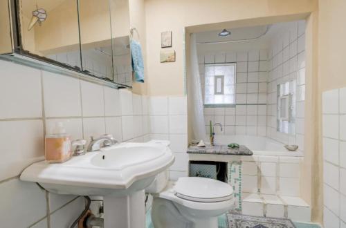 a bathroom with a sink and a toilet and a tub at Hillmont paradise in Oakland