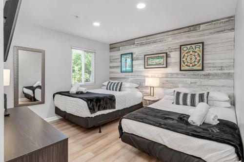 a bedroom with two beds and a mirror at Nashville Oasis Walk to Broadway with POOL, Parking, Gym and Patio in Nashville