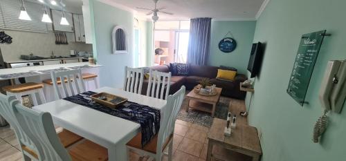 a kitchen and a living room with a table and chairs at Oceanic Breeze in Margate