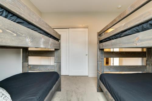 two bunk beds in a room with a door at Ski-InandSki-Out Granby Getaway with Fire Pit! in Granby