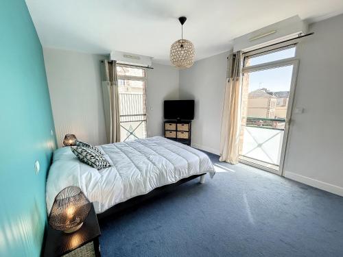 a bedroom with a bed and a large window at Appartement rénové avec ascenseur - Proche plage et centre-ville - FR-1-361-506 in Saint-Pair-sur-Mer