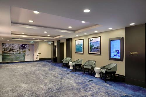 a waiting room with chairs and posters on the wall at Hotel 1000, LXR Hotels & Resorts in Seattle