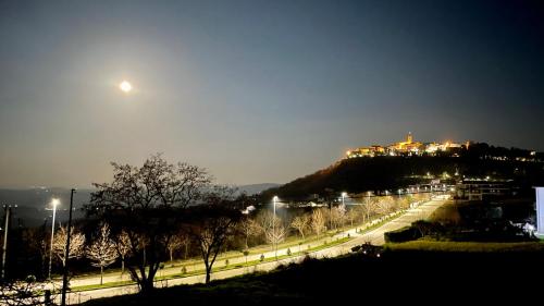 a view of a city at night with the moon at B&B Ciocca I in Campobasso