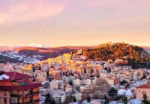 a view of a city with snow on a mountain at B&B Ciocca I in Campobasso