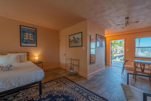 a bedroom with a bed and a table and chairs at Tropical Breeze in Clearwater Beach