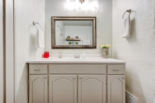 a bathroom with a sink and a mirror at Lincoln Lodge B Near OU Med Bricktown Arena in Oklahoma City