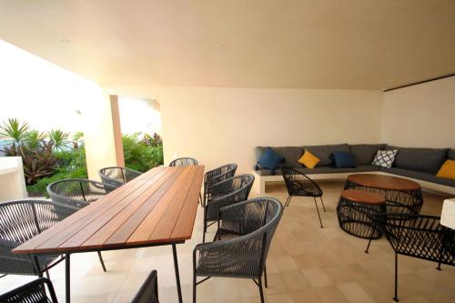 a room with a table and chairs and a couch at Apartment near the beach, rooftop, pool, sea view. in Playa del Carmen