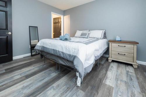 a bedroom with a large bed and a wooden floor at Little 500 Quarters in Bloomington
