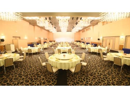 een feestzaal met witte tafels en stoelen bij Hotel 1-2-3 Maebashi Mercury - Vacation STAY 01042v in Maebashi