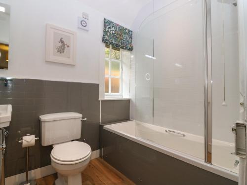 a bathroom with a toilet and a tub and a sink at West Cottage - Tarvit in Cupar