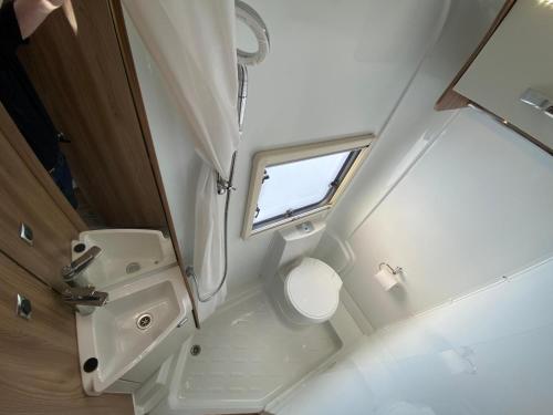 a small bathroom with a toilet and a sink at Swift Escape 664 - 4 Berth Motorhome in Kirton