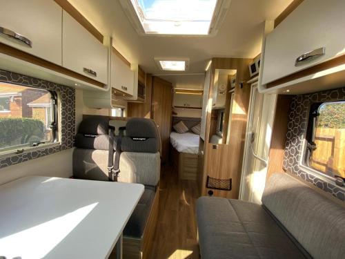 an interior view of an rv with a bedroom at Swift Escape 664 - 4 Berth Motorhome in Kirton