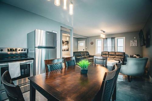 a kitchen and dining room with a table and a refrigerator at The Horseshoe Falls Villa in Niagara Falls