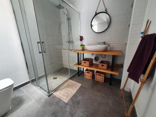 a bathroom with a sink and a glass shower at Mazagón relaj in Palos de la Frontera