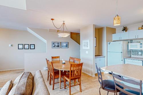 a kitchen and dining room with a table and a couch at SnowCrest Village, Unit 5 in Big White