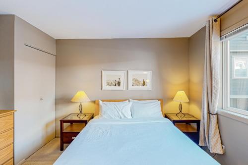 a bedroom with a large bed and two lamps at SnowCrest Village, Unit 5 in Big White