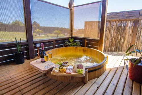 a large wooden tub sitting on a deck at Altos de Pichilemu in Pichilemu