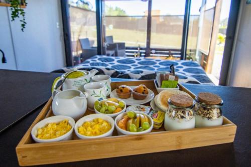 a tray of food on a table with breakfast foods at Altos de Pichilemu in Pichilemu