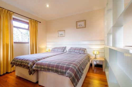 a small bedroom with a bed and a window at Shilbury Retreat Cottage in Perranporth