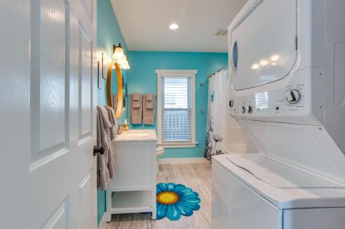 a bathroom with a sink and a washer and dryer at Charming Missouri Home Less Than 1 Mi to Katy Trail! in Pleasant Hill