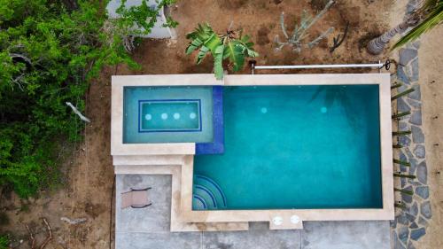 an overhead view of a swimming pool with a television at Villas Del Scarlet Cardones in Pescadero