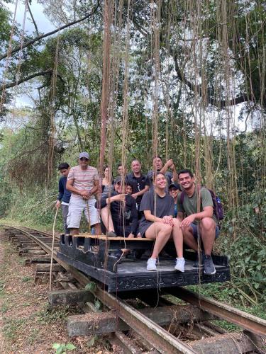 a group of people sitting on a suspension bridge at Refugio Mirador del Ocaso in Zipacón