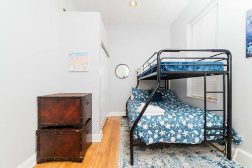 a bedroom with a bunk bed and a suitcase at Outdoor Space - Parking - 1st Floor - Walkable in Pittsburgh