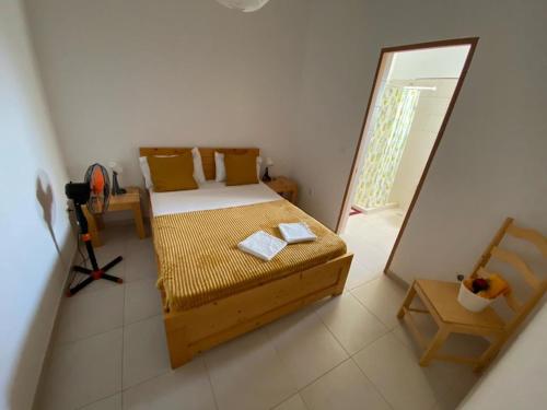 a small bedroom with a bed and a mirror at Pousada Cantinho de Preta in Seladinha