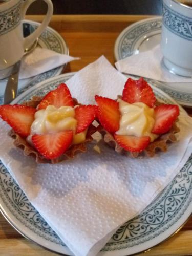 a plate with strawberries and cream on a table at Hotel Concepción Antioquia in Concepción