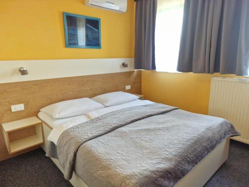 a bedroom with a bed and a window at Pri štorklji in Moravske Toplice