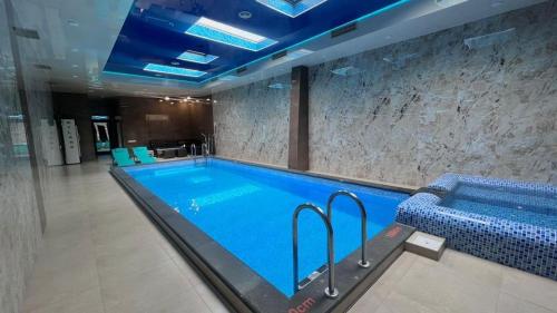 a large swimming pool in a building with at MYLAND HOTEL in Tsaghkadzor