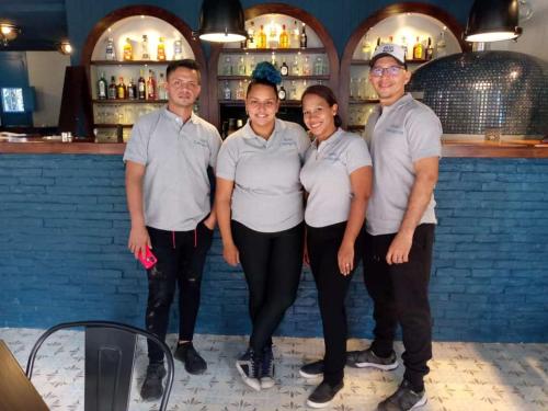 a group of people standing in front of a bar at Hotel Concepción Antioquia in Concepción