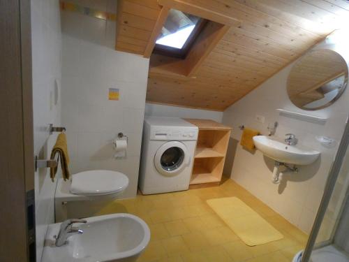 a bathroom with a sink and a washing machine at Casa Gogn in San Vigilio Di Marebbe
