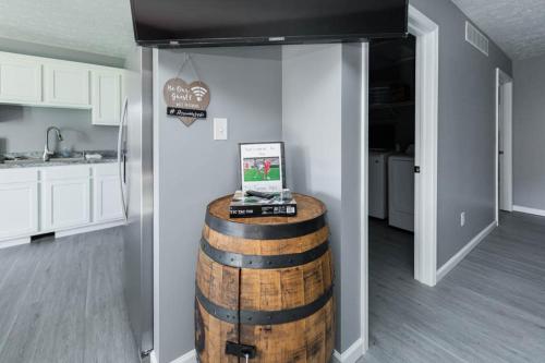 a room with a wine barrel in the middle of a kitchen at IU Soccer HIdeaway in Bloomington