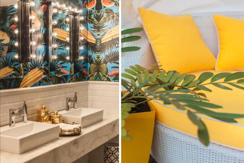 ein Badezimmer mit einem Waschbecken und einer gelben Wand in der Unterkunft Brown Beach House Tel-Aviv, a member of Brown Hotels in Tel Aviv
