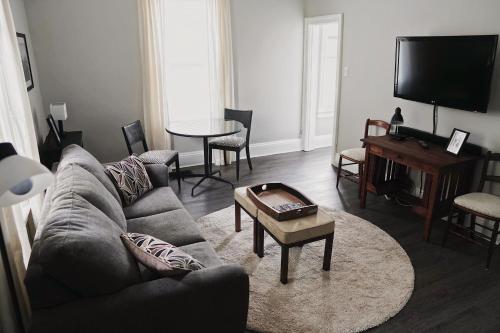 a living room with a couch and a table at The Trafalgar in Oakville