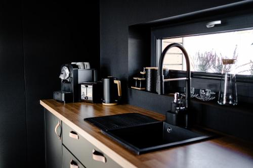 a kitchen counter with a sink and a window at Wimer Domki in Wysowa-Zdrój