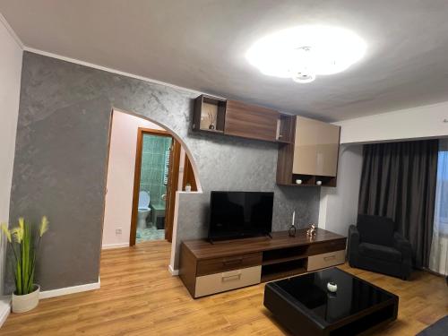 a living room with a flat screen tv and a couch at Best Rent Apartments in Giurgiu