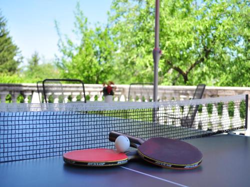 two tennis rackets and balls on a tennis court at Guest House Surina in Rupa