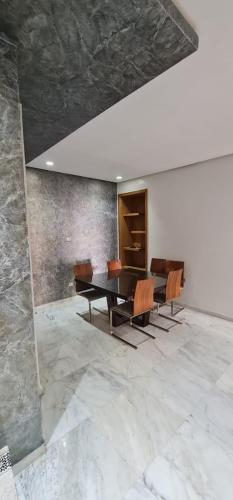 a dining room with a table and chairs at Jnane Californie in Casablanca