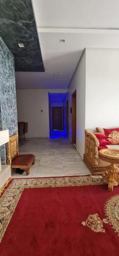 a room with a bed and a blue light at Jnane Californie in Casablanca
