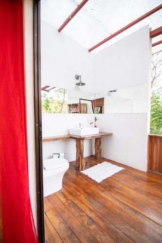 a bathroom with a toilet and a sink at Marbella Retreats Casa Roja in Santa Cruz