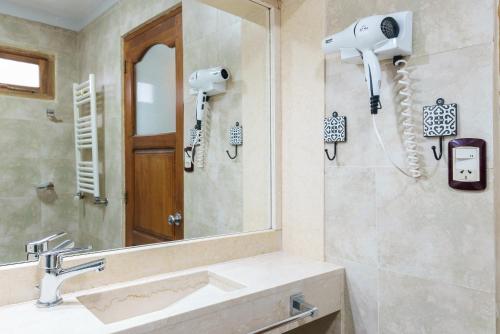 a bathroom with a sink and a mirror at Cabañas Tierra Mistica in Ushuaia