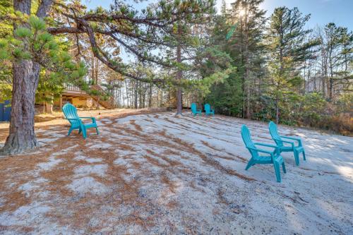 a group of blue chairs sitting in the sand at Near Skiing Lakefront Gem with Kayaks in Long Pond in Long Pond