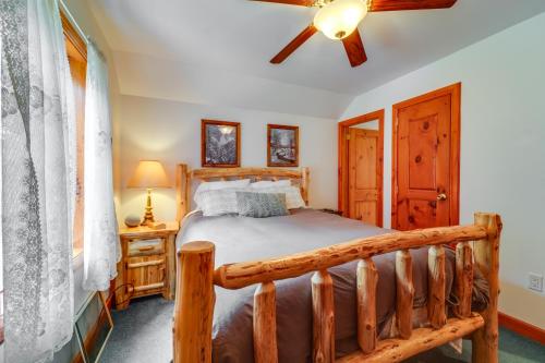 a bedroom with a wooden bed and a ceiling fan at Cozy Greig Getaway - 1 Mi to Brantingham Lake! in Glenfield